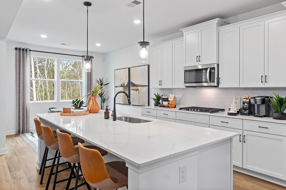 A kitchen with white cabinets.
