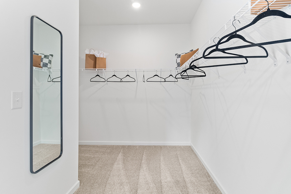 A room with a glass door and a mirror.