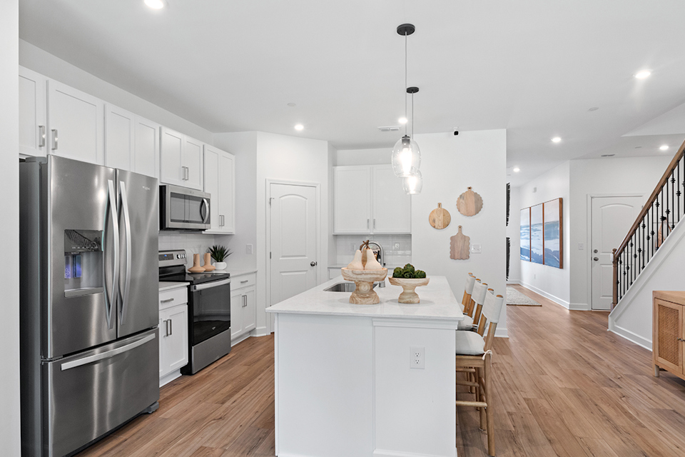 A kitchen with white cabinets.