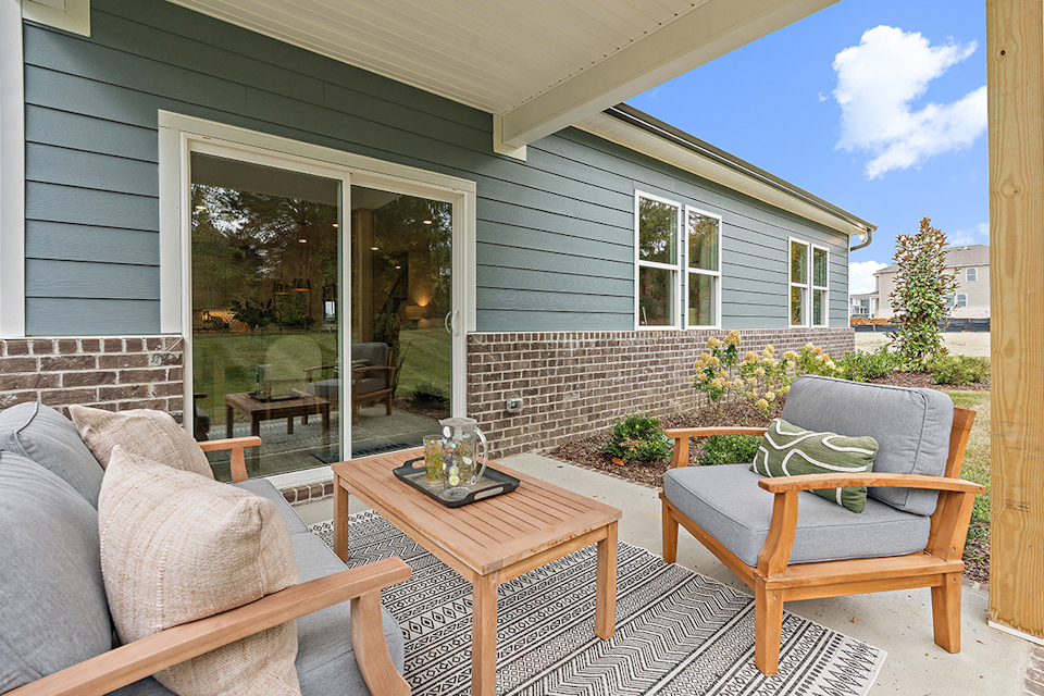 A patio with a table and chairs.