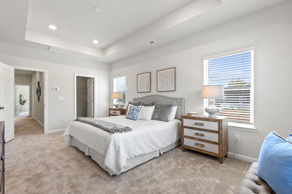 A bedroom with a bed and a dresser.