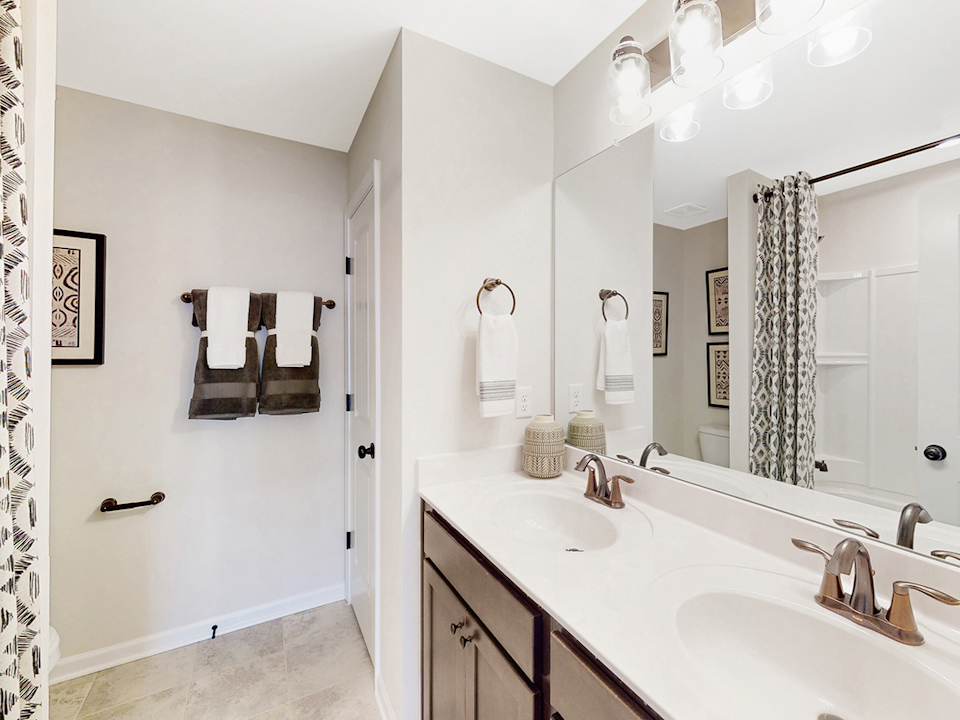 A bathroom with a large mirror.