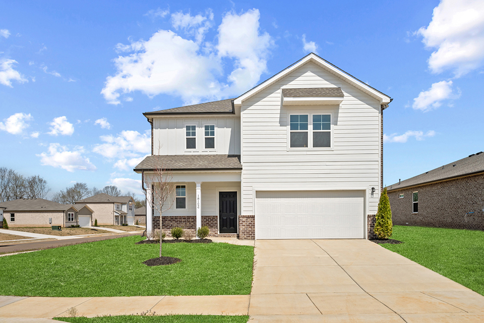 A white house with a driveway.