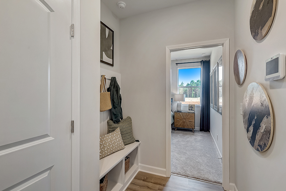 A room with a bed and a mirror.