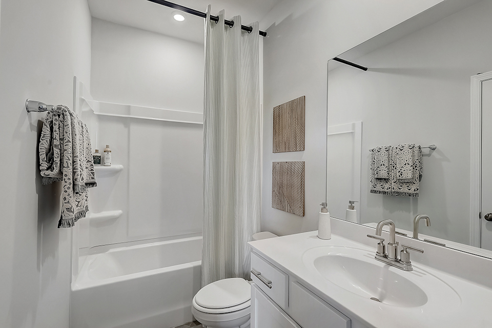 A bathroom with a sink and a shower.