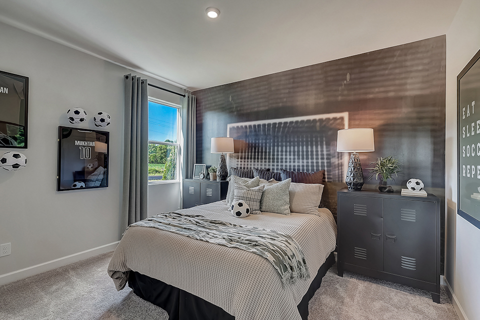 A bedroom with a bed and lamps.