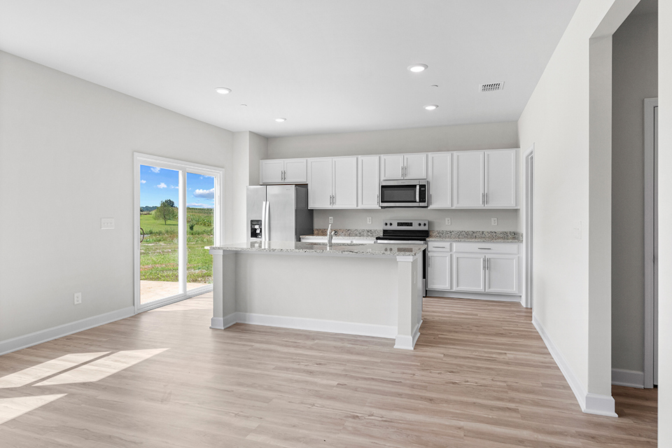 A kitchen with white cabinets.