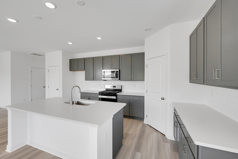 A kitchen with white cabinets.