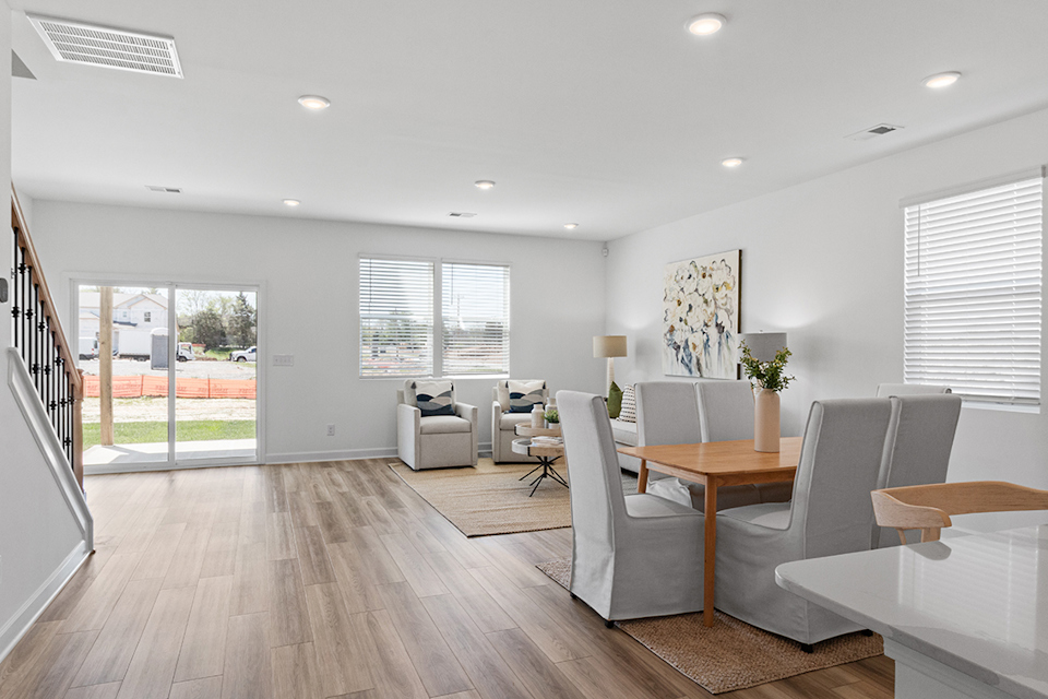 A room with a table chairs and a window.