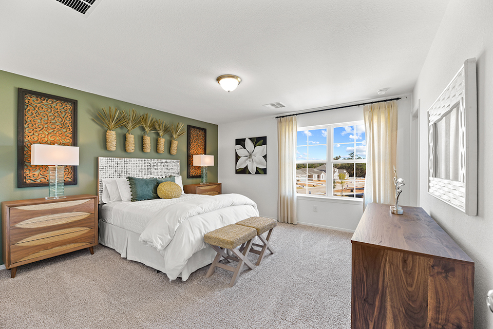 A bedroom with a bed and a desk.