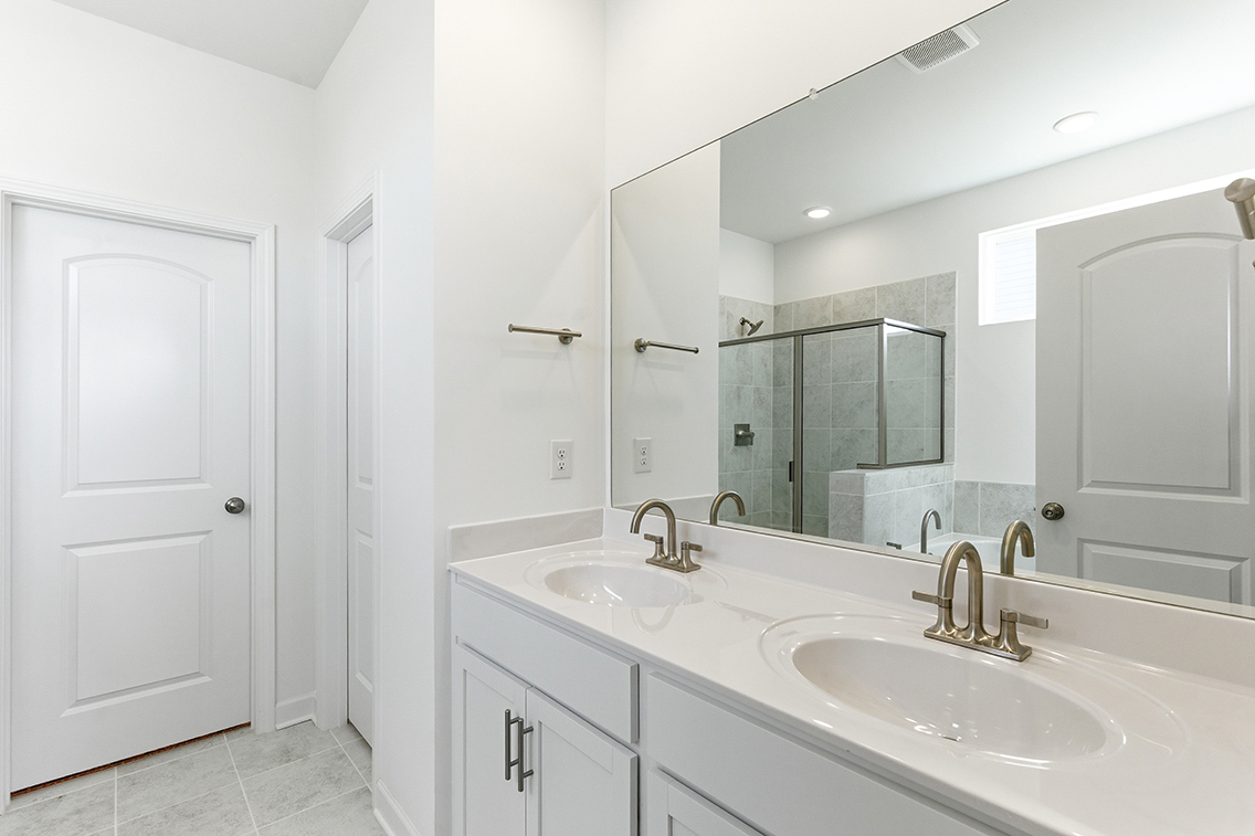 A bathroom with a large mirror.