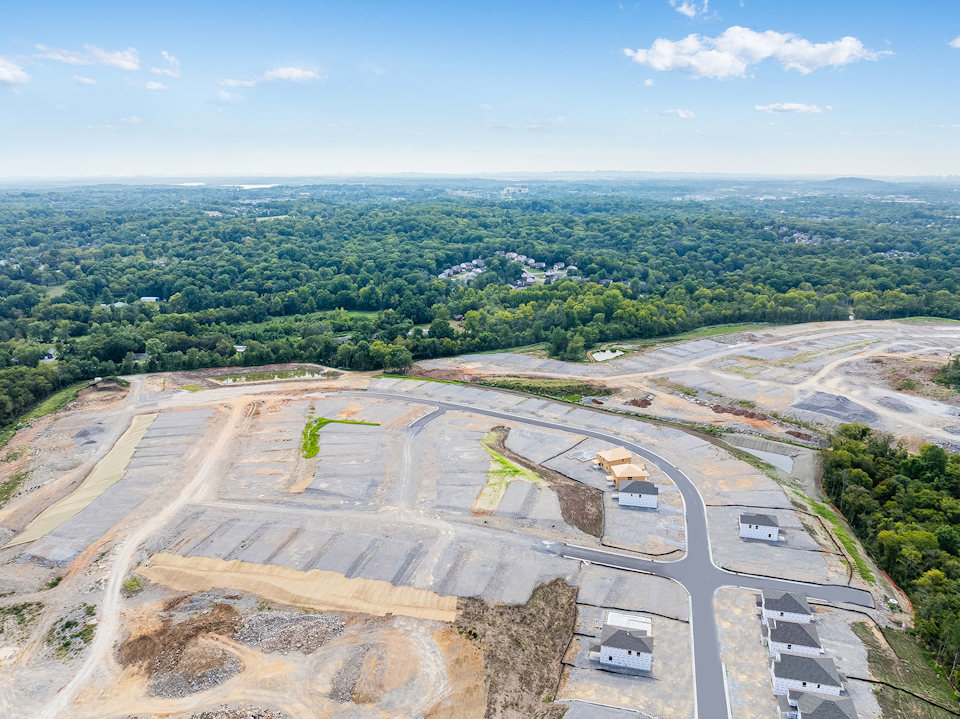 A large area with a road and trees in the background.