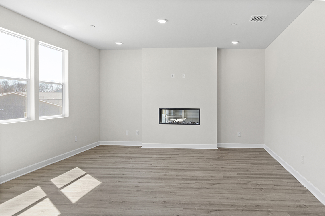 A room with a wood floor and a window with a picture on it.
