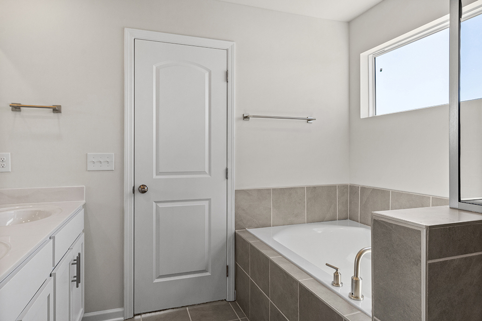 A bathroom with a tub and sink.
