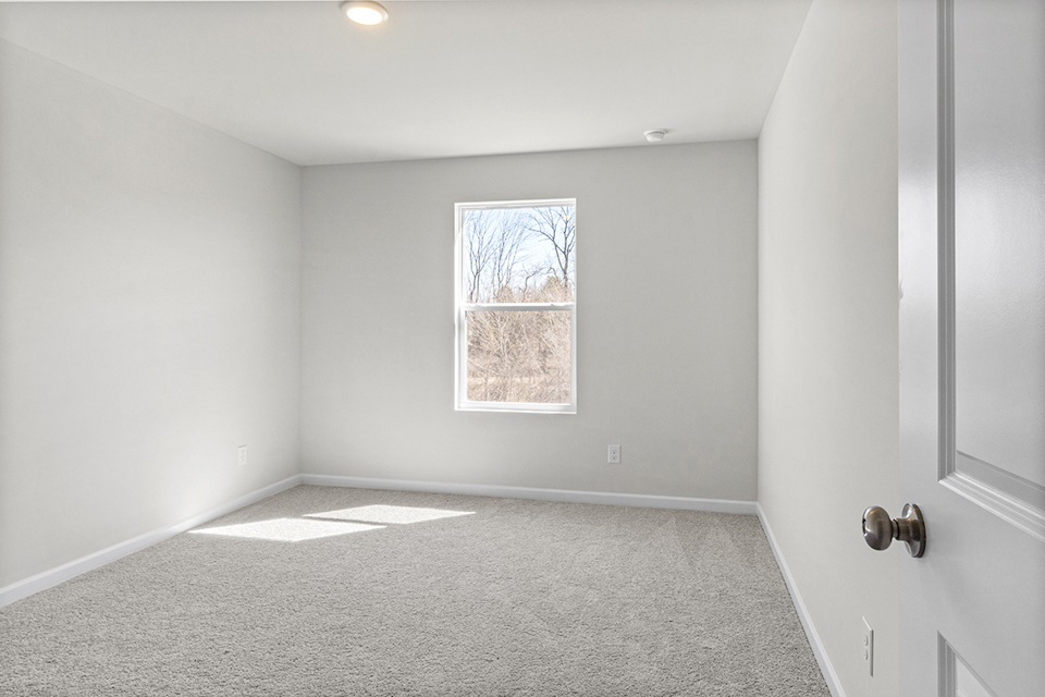 A room with a window and a door.