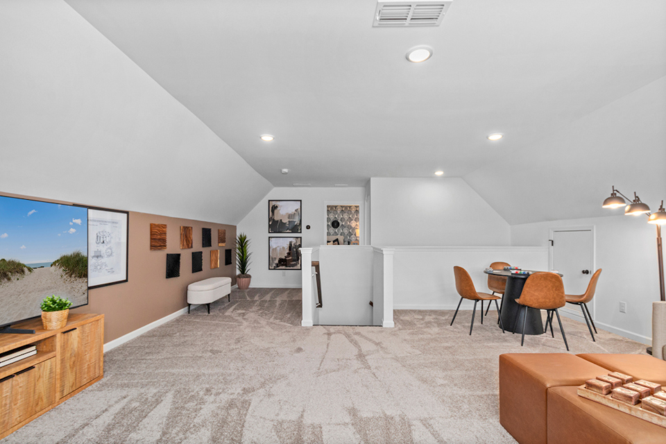 A room with a table chairs and a couch.