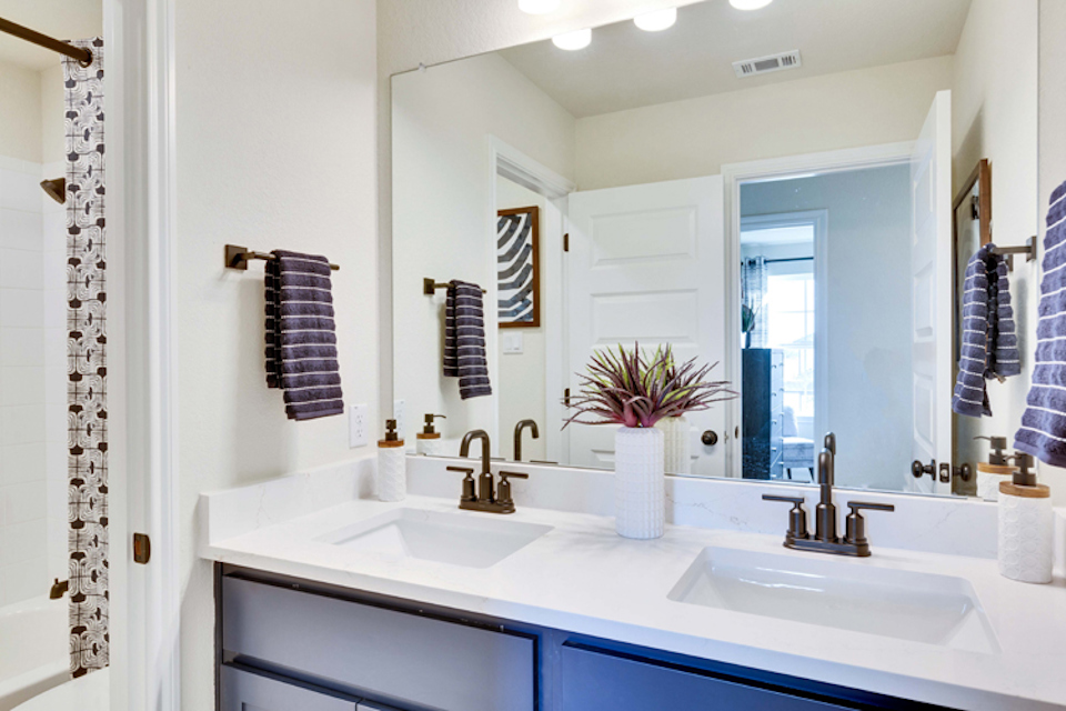 A bathroom with a mirror and sink.