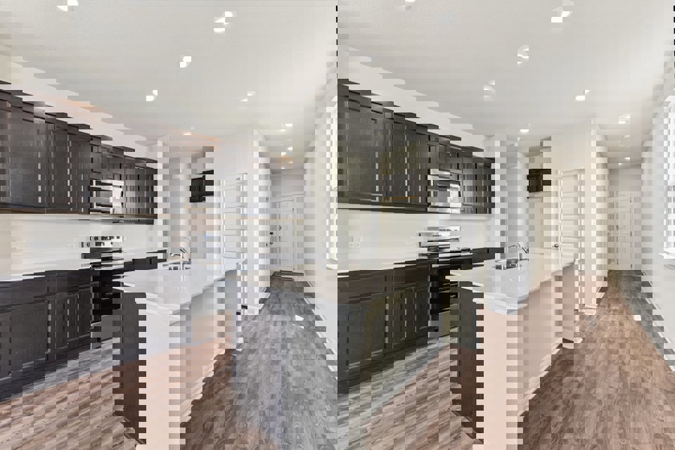 A kitchen with black cabinets.