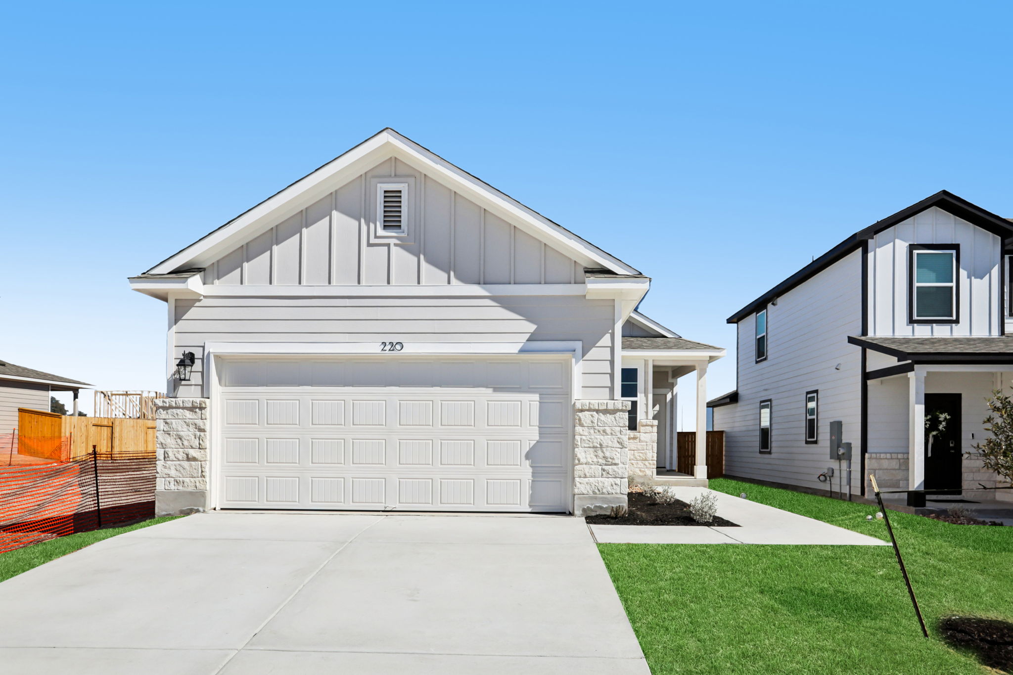 A white house with a garage.