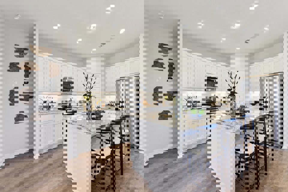 A kitchen with white cabinets.