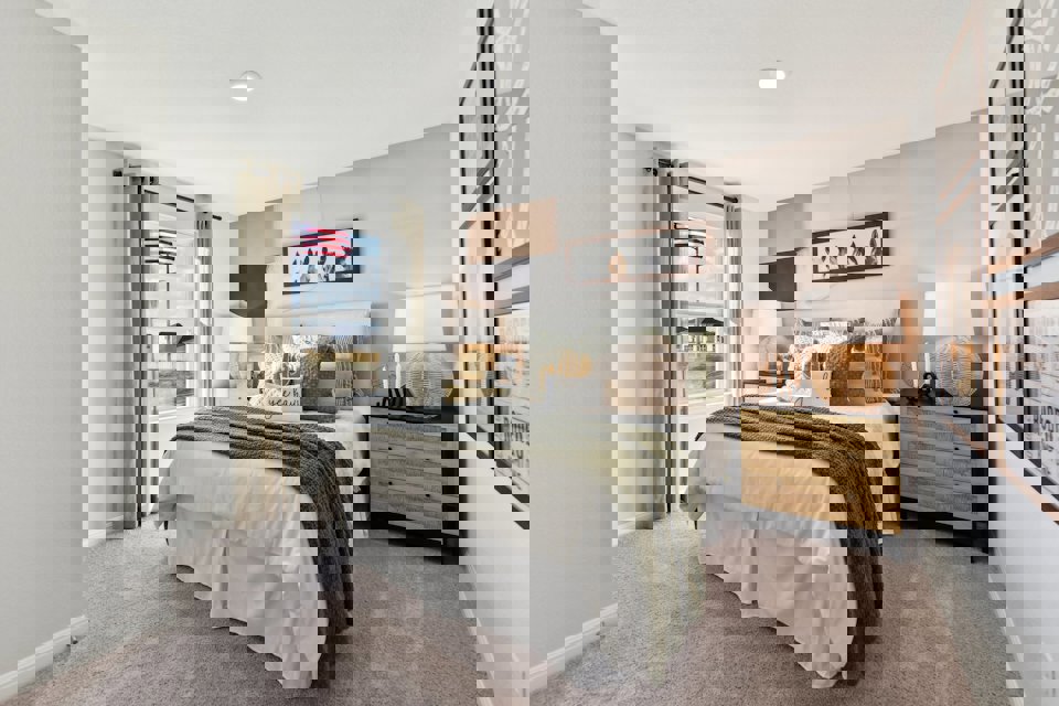 A bedroom with a bed and lamps.