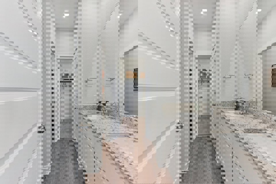 A bathroom with a marble countertop.