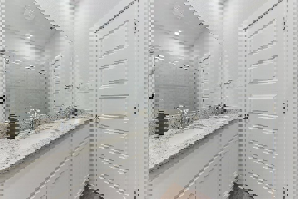 A bathroom with a large mirror.