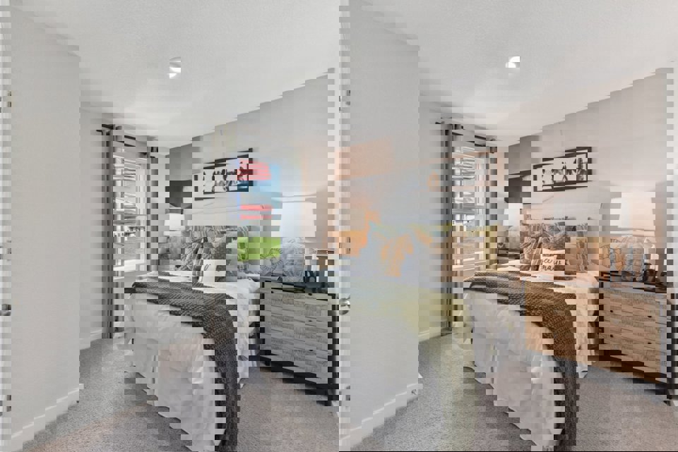 A bedroom with a bed and a dresser.