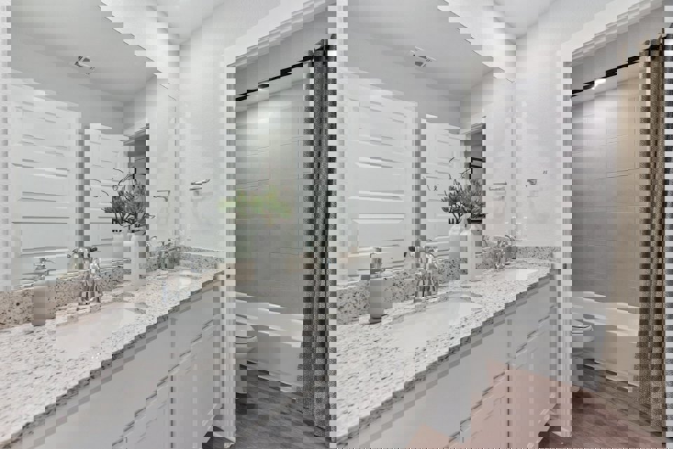 A bathroom with a tub sink and toilet.