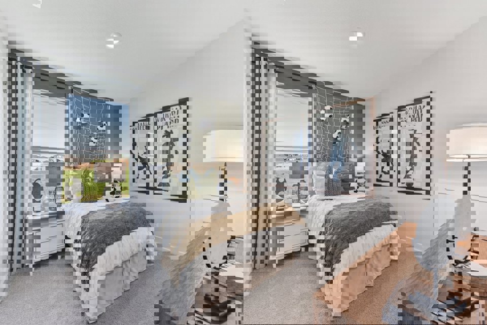 A bedroom with a bed and a desk.