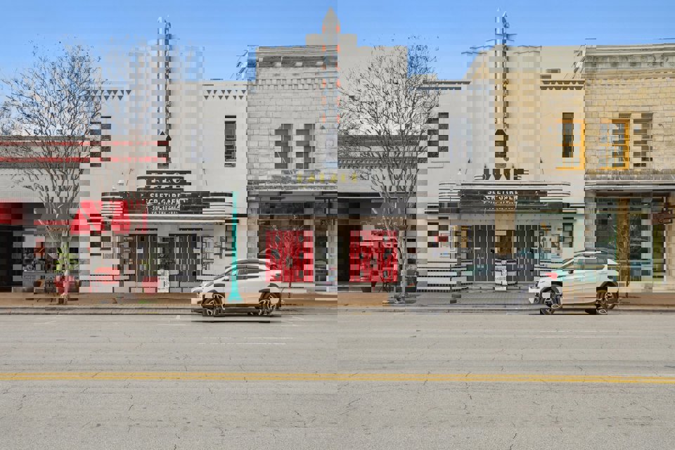 A white car parked in front of a building.