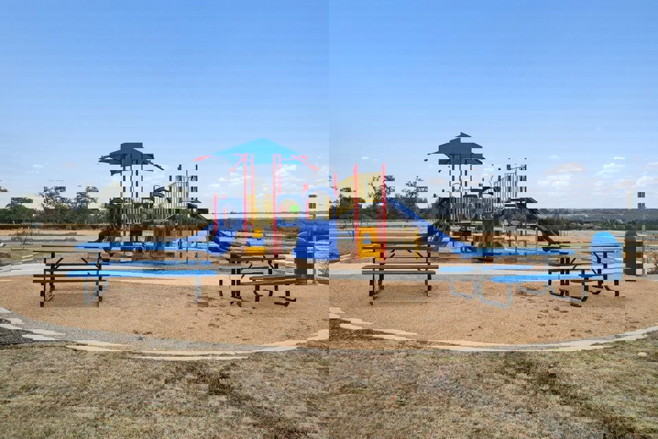 A playground with blue benches.