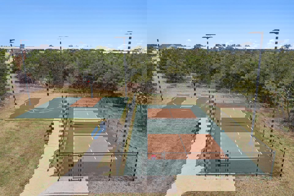 A tennis court with a fence.