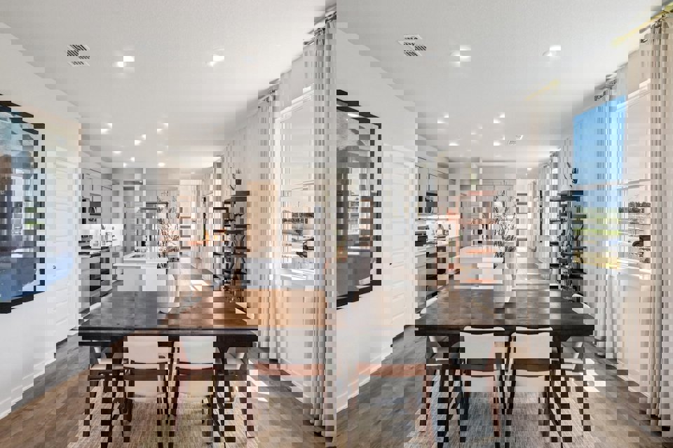 A dining room table with chairs.