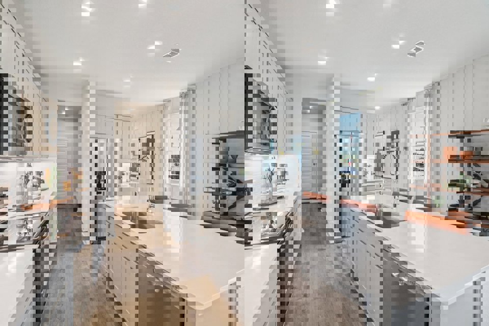 A kitchen with white cabinets.