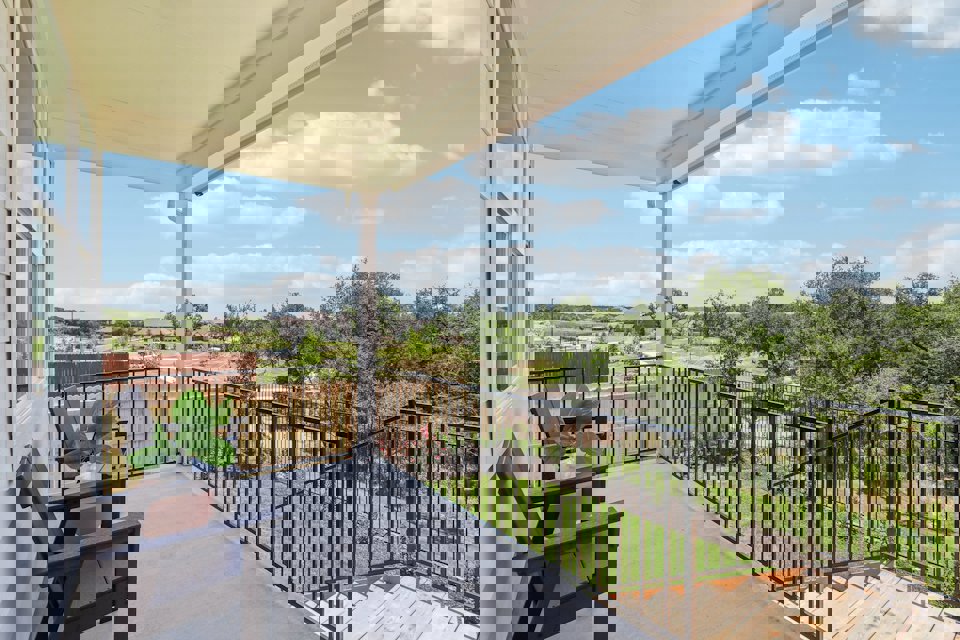 A deck with a railing and trees.