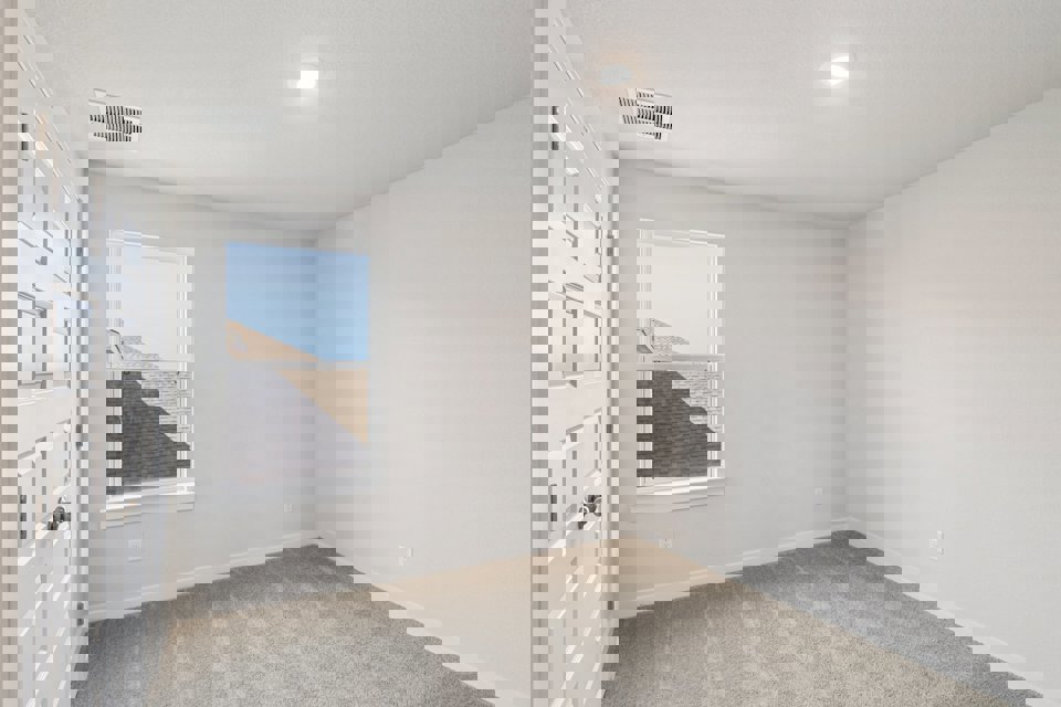 A room with a window and a door.