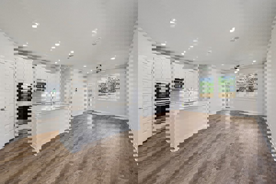 A kitchen with white cabinets.