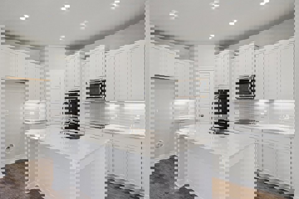 A kitchen with white cabinets.