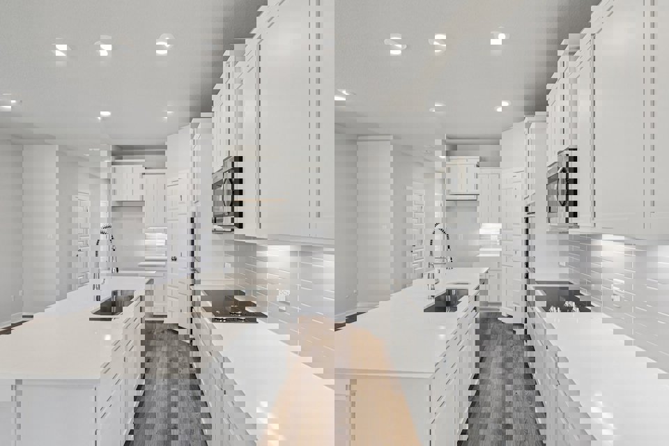 A kitchen with white cabinets.