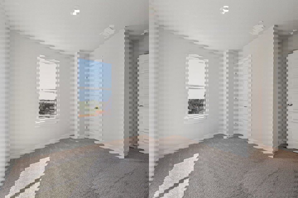 A room with white walls and a window.