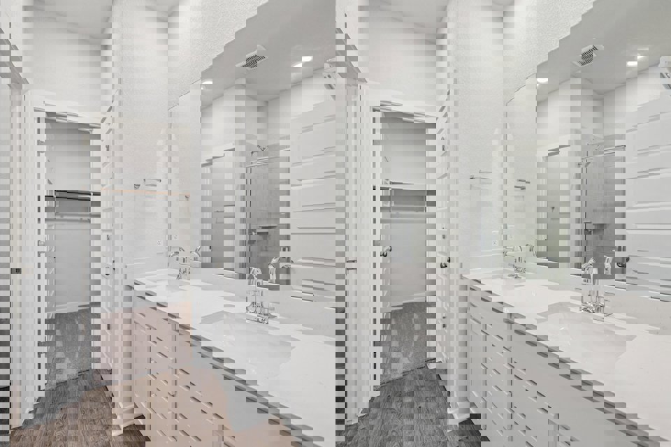 A bathroom with a large mirror.