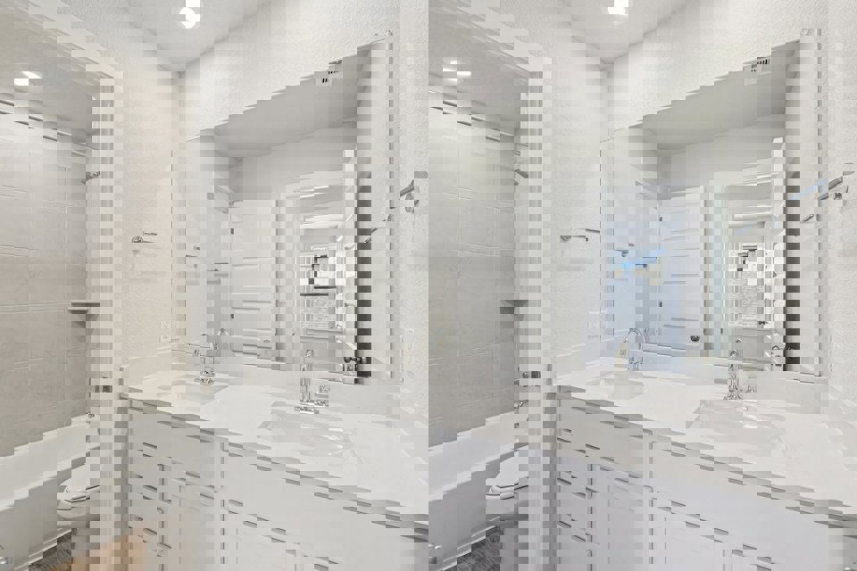 A bathroom with a tub sink and toilet.