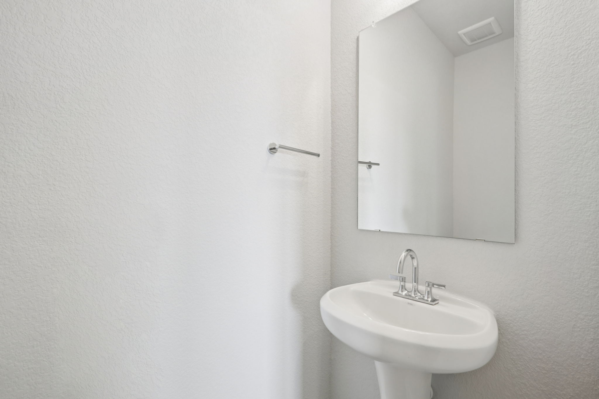 A bathroom with a mirror and sink.