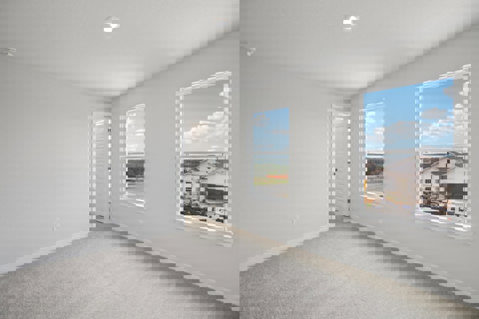 A room with a window and a painting on the wall.