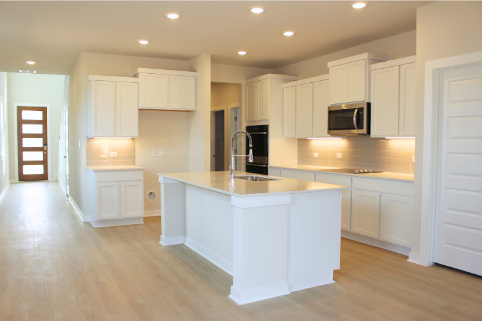 A gourmet kitchen with white cabinets.