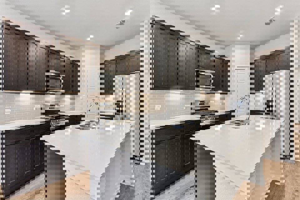 A kitchen with black cabinets.