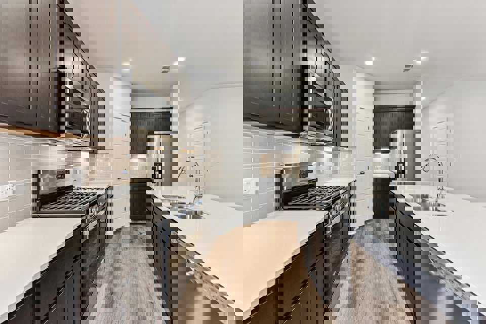 A kitchen with black cabinets.