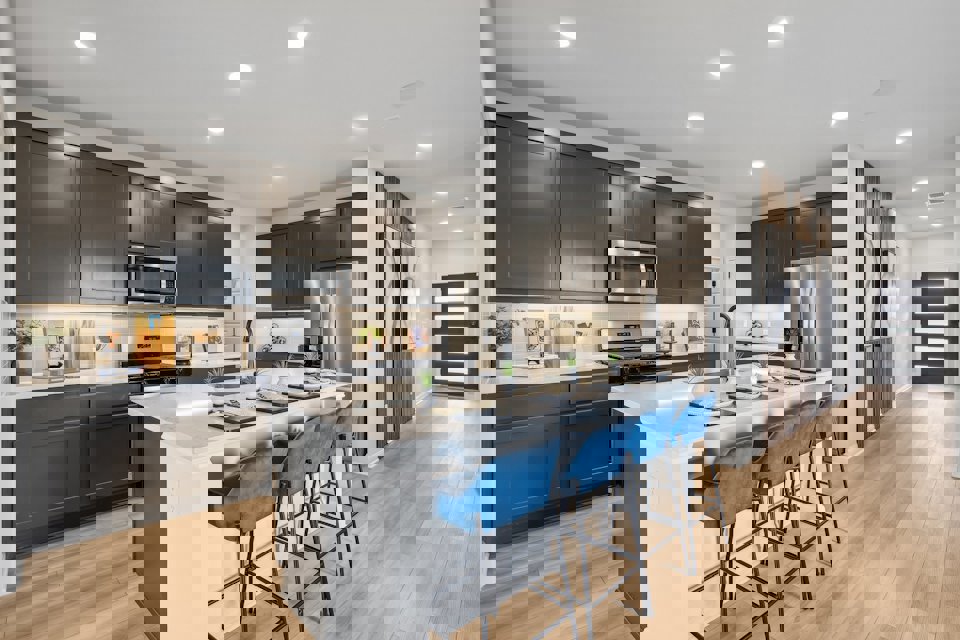 A kitchen with black cabinets.