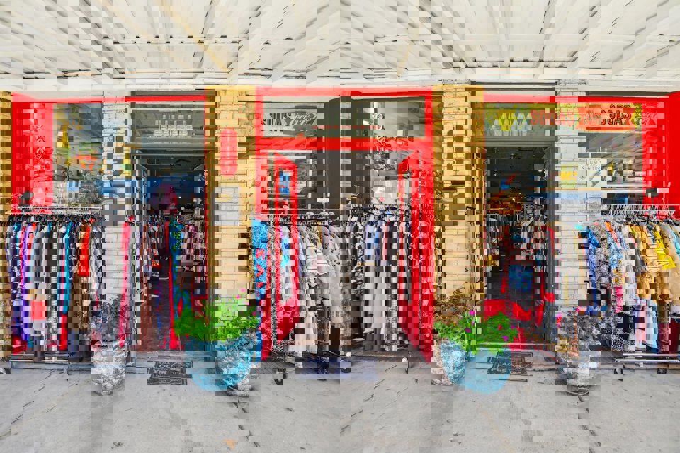 A store front with a large display of clothes.